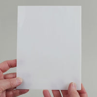 Video of the white glass plate in white semi-transparant, 15x19cm, held up and tilted to show its pattern and transparency