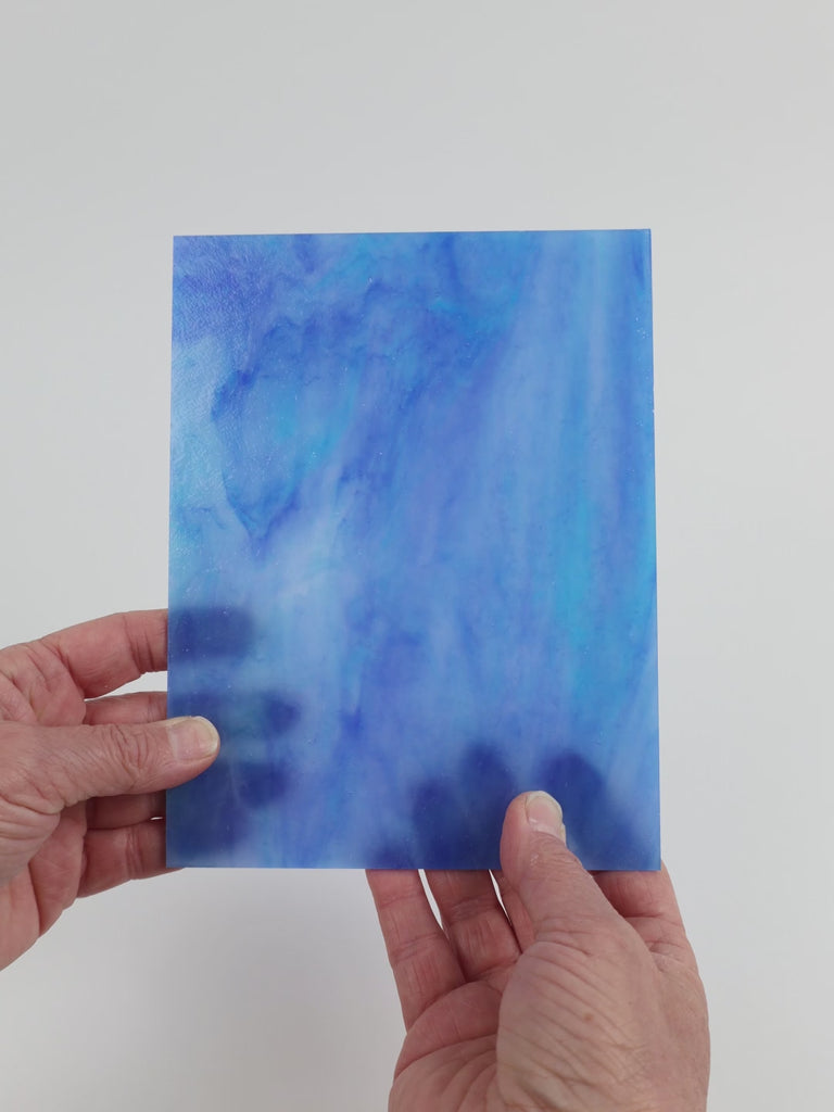 Video of the Dream Blue glass plate in translucent blue, 15x19cm, held up and tilted to show its pattern and transparency
