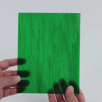 Video of the Secret Garden glass plate in translucent green, 15x19cm, held up and tilted to show its pattern and transparency