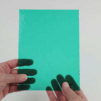 Video of the Teal glass plate in transparent teal, 15x19cm, held up and tilted to show its pattern and transparency