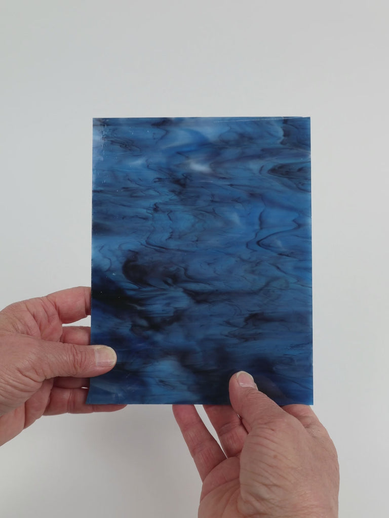 Video of the Indigo Charcoal glass plate in translucent blue, 15x19cm, held up and tilted to show its pattern and transparency