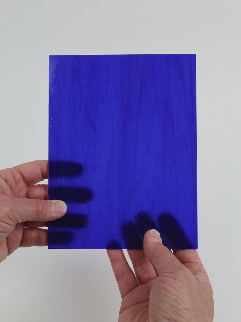 Video of the Lapis Lazulli glass plate in translucent blue, 15x19cm, held up and tilted to show its pattern and transparency