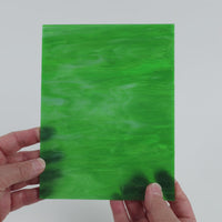 Video of the Fern Wispy glass plate in translucent green, 15x19cm, held up and tilted to show its pattern and transparency