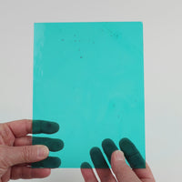 Video of the Aqua glass plate in transparent blue, 15x19cm, held up and tilted to show its pattern and transparency