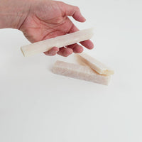 Video of Marble Bars XL Onyx in opaque beige natural onyx, 1–20 cm long and 8 mm thick, picked up by hand and turned to show their length, colour and banded texture