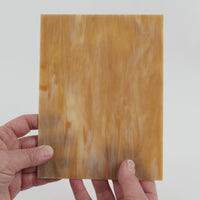 Video of the butterscotch glass plate in brown translucent, 15x19cm, held up and tilted to show its pattern and transparency