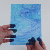Video of the Pale Turquoise Wave Ripple glass plate in ripple transparent turquoise, 15x19cm, held up and tilted to show its pattern and transparency